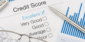 Credit score ratings on a paper with Excellent check marked