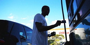 A man at the gas station about to insert his credit card
