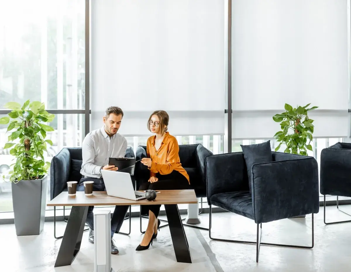 two people looking at computer two people looking at computer