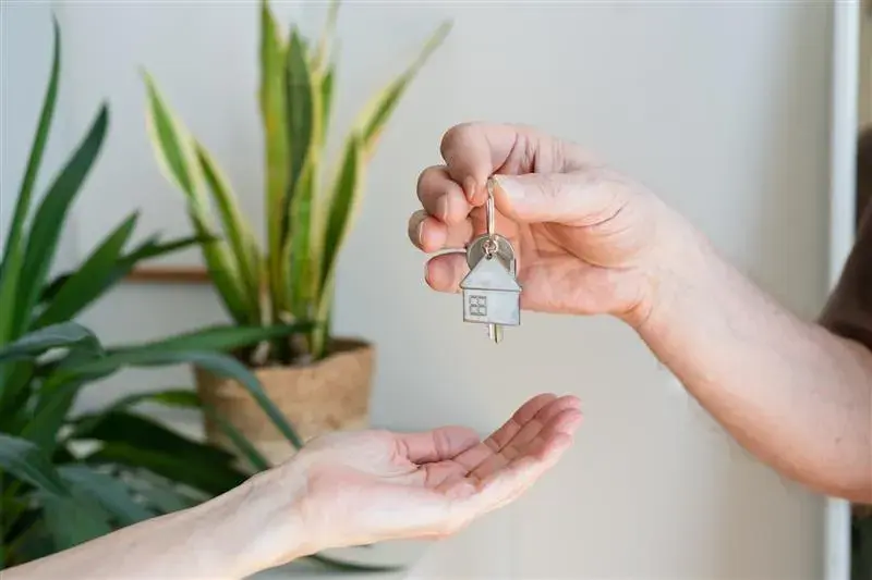 person handing over keys person handing over keys