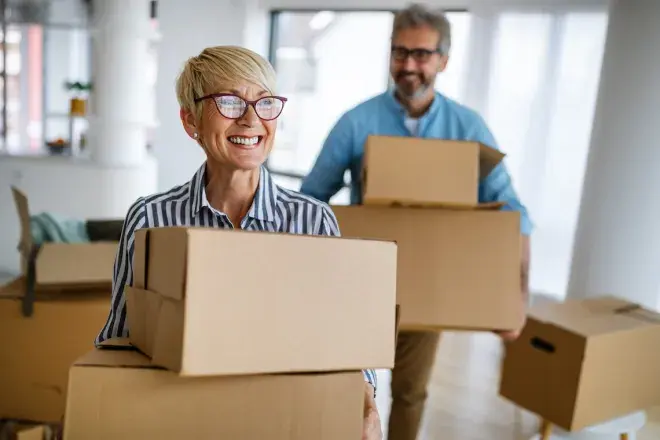 happy senior couple moving boxes into new home happy senior couple moving boxes into new home