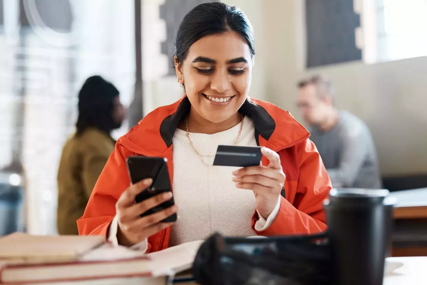 person making a purchase on phone with credit card person making a purchase on phone with credit card