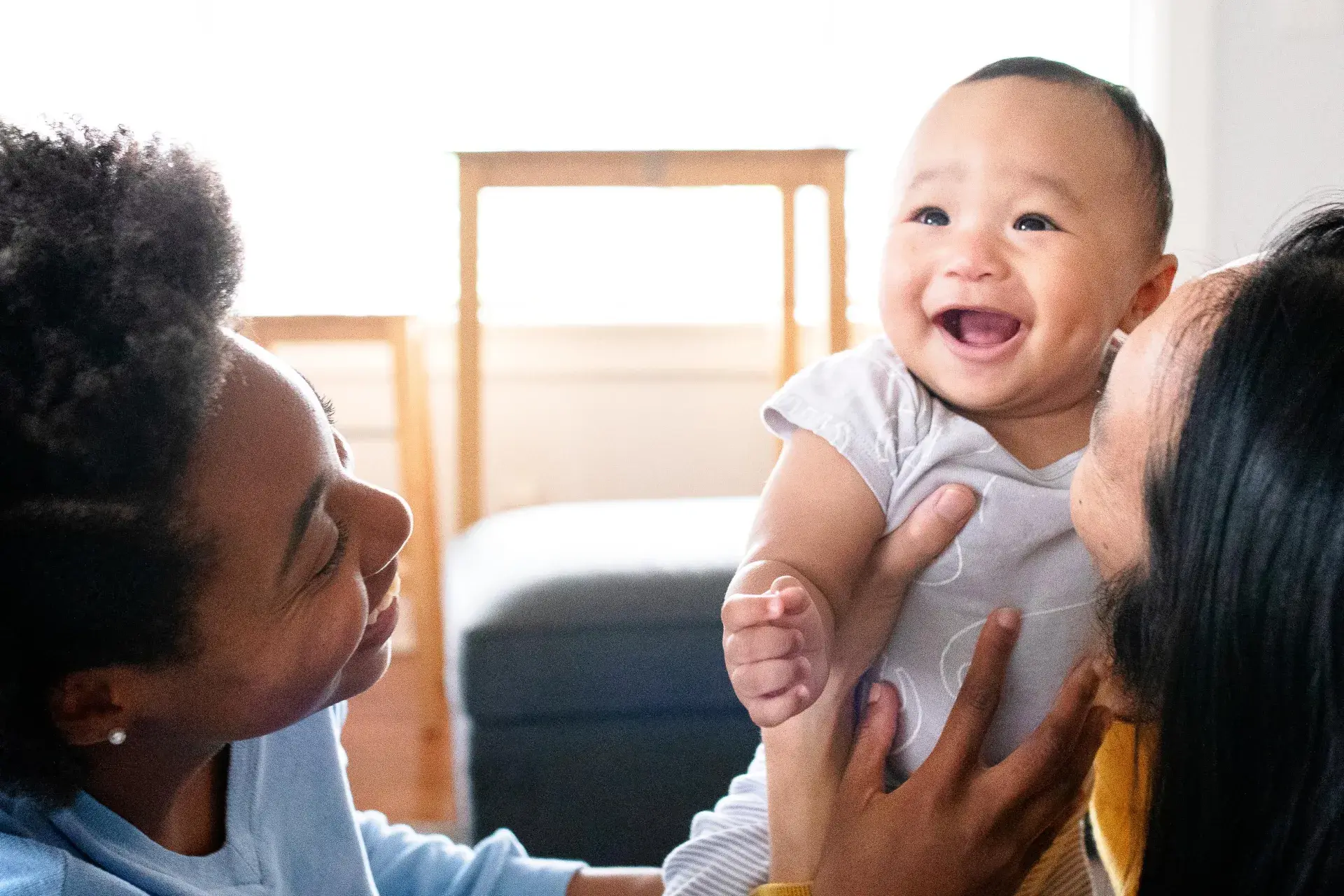 Couple holding smiling baby Couple holding smiling baby